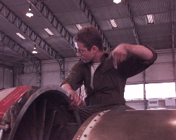 Steve Wiltshire of the ThrustSSC Engine Team guides a Spey into place