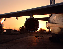 The sun setting behind the Antonov while unloading continues