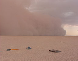 The storm front advances across the desert