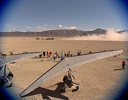 ThrustSSC raises the dust as Andy increases power. In the foreground are the Pegasus microlights on standby.