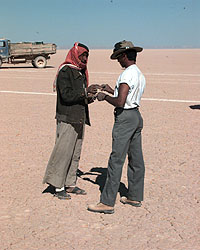 A Bedouin exchanging cigarettes with Pete Ross