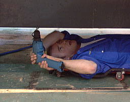 Steve Wiltshire removes body panels below the engines