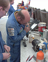 Robert Atkinson and Steve O'Donnell work on an electronics box