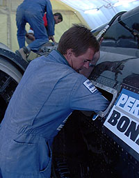 Rob Hemper guides the hydraulic hose to the accumulators